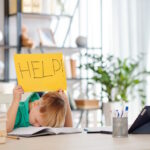 child holding help sign